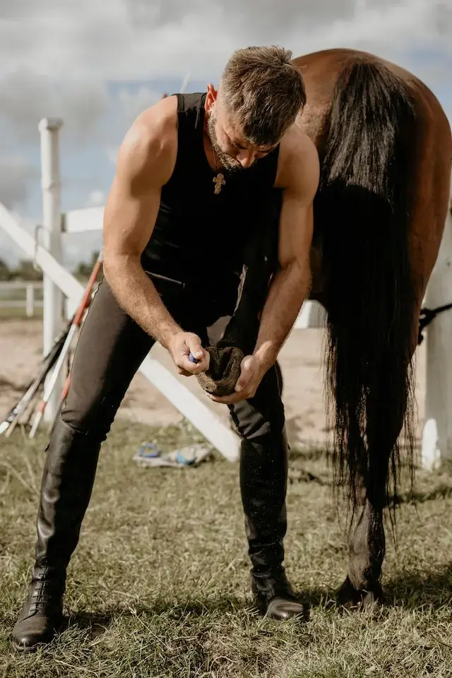 Do horses like their hooves cleaned? Man Removing a Horse Shoe.